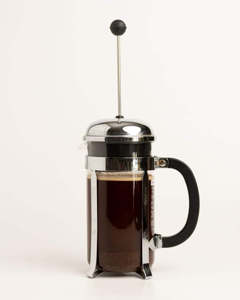 French press with top on, without plunger submerged.